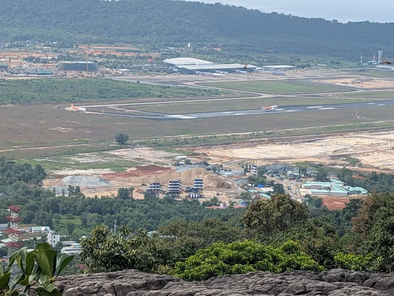 Elevated view over Phu Quoc airport runway with planes, terminal building and surrounding construction sites. Elevated view over Phu Quoc airport runway with planes, terminal building and surrounding construction sites.