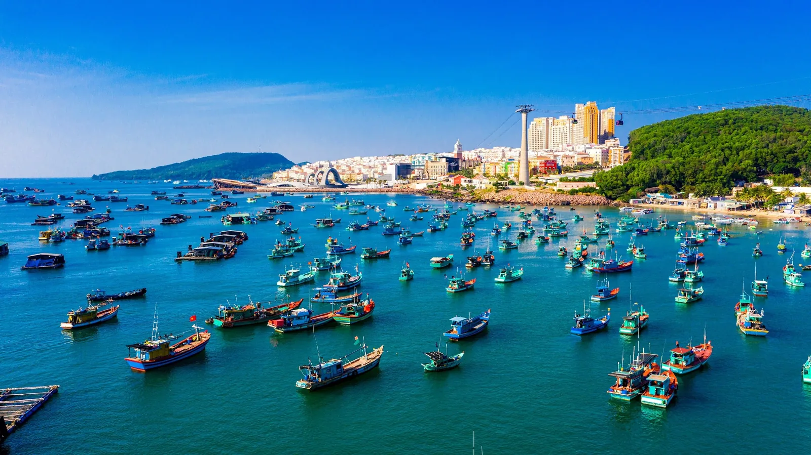 Colorful fishing boats fill the harbor at An Thoi town on Phu Quoc island under a clear blue sky. Colorful fishing boats fill the harbor at An Thoi town on Phu Quoc island under a clear blue sky.